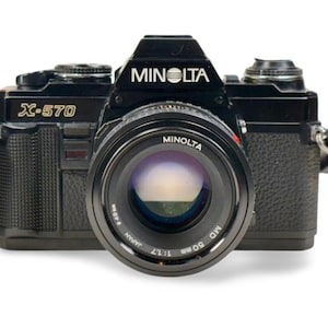 Minolta X-570 with 50mm 1.7 lens. Fully functioning.