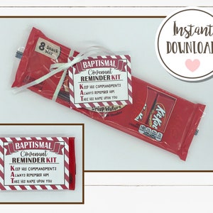 May include: A red and white striped card with the text "Baptismal Covenant Reminder Kit" and the words "Keep His Commandments, Always Remember Him, Take His Name Upon You". The card is tied with a white ribbon to a red and white candy bar.