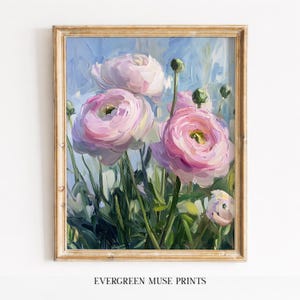 May include: A framed floral print featuring large, pink ranunculus flowers with green stems and buds against a blue background. The artwork is in a gold-colored frame. The text "EVERGREEN MUSE PRINTS" is at the bottom.