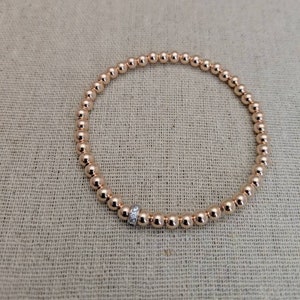 High Quality Gold Filled Rose Gold or Yellow Gold Beaded Bracelet with Hint of Silver CZ Bead.