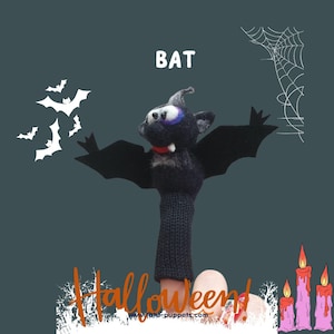 Può includere: Un burattino per dita di feltro nero a forma di pipistrello con un colletto rosso e zanne bianche. Il pipistrello tiene le ali aperte e ha un occhio blu. Il burattino è su un dito con smalto nero. Lo sfondo è grigio scuro con pipistrelli bianchi e una ragnatela bianca. Il testo "BAT" è in lettere bianche nella parte superiore dell'immagine. Il testo "Halloween!" è in lettere arancioni nella parte inferiore dell'immagine.
