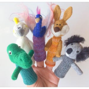 May include: Five finger puppets made of felt and yarn. The puppets are a green crocodile, a white cockatoo, a blue peacock, a brown rabbit, and a gray koala.