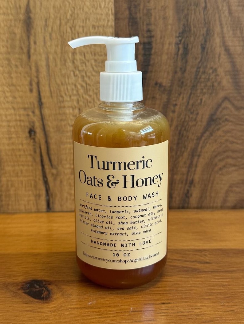 May include: A clear plastic bottle of face and body wash with a white pump dispenser. The label reads "Turmeric Oats & Honey" and lists ingredients. The bottle contains 296 ml of product.