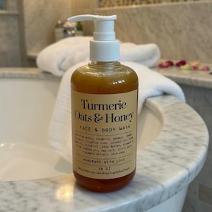 May include: A clear bottle of Turmeric Oats & Honey Face & Body Wash with a white pump dispenser. The label includes the ingredients and the words "Handmade with Love". The bottle contains approximately 532 ml of product.