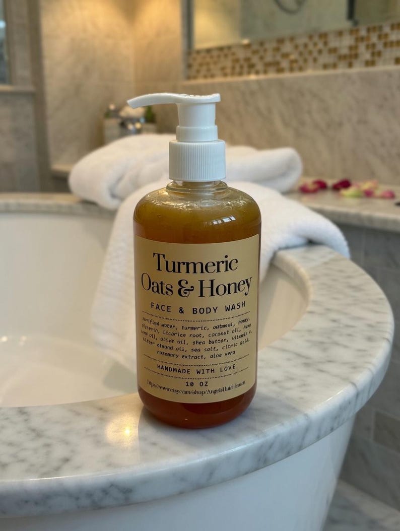 May include: A clear bottle of Turmeric Oats & Honey Face & Body Wash with a white pump dispenser. The label includes the ingredients and the words "Handmade with Love". The bottle contains approximately 532 ml of product.