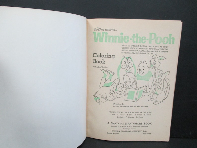 May include: Winnie-the-Pooh colouring book cover featuring illustrations of Winnie-the-Pooh, Piglet, Eeyore, Tigger, and Owl. The book is an authorised edition and includes a colour code for the pictures.
