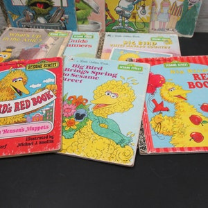 May include: A collection of vintage Sesame Street children's books featuring Big Bird. The books have colorful covers with illustrations of Big Bird and other Sesame Street characters. The titles include "Big Bird's Red Book", "Big Bird Brings Spring to Sesame Street", and "Big Bird Visits Navajo Country".