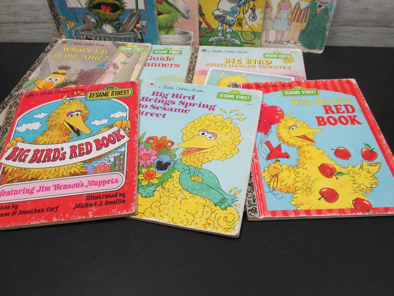 May include: A collection of vintage Sesame Street children's books featuring Big Bird. The books have colorful covers with illustrations of Big Bird and other Sesame Street characters. The titles include "Big Bird's Red Book", "Big Bird Brings Spring to Sesame Street", and "Big Bird Visits Navajo Country".