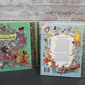 May include: A stack of vintage Little Golden Books with colorful covers featuring popular cartoon characters like Mickey Mouse, Donald Duck, Bugs Bunny, and Big Bird. The books have a green and gold spine with the words "Little Golden Books" printed on the spine.