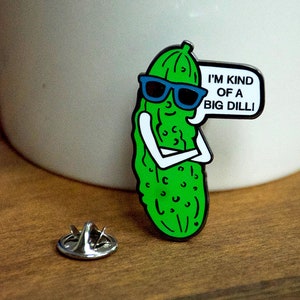 May include: A green pickle wearing sunglasses and a speech bubble that says "I'm kind of a big dill!" Enamel pin.