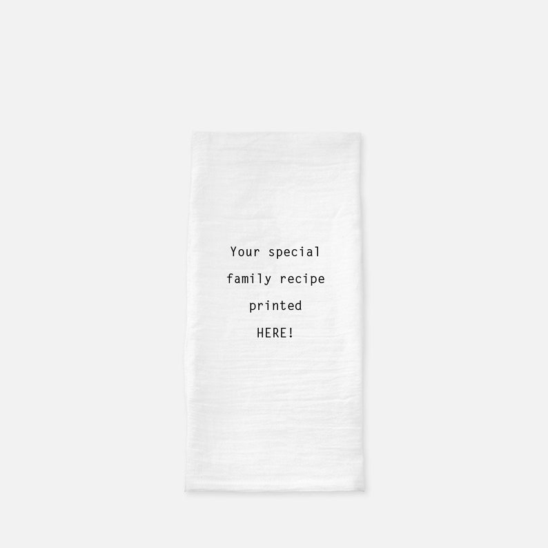 May include: White kitchen towel with the text "Your special family recipe printed HERE!" in black.