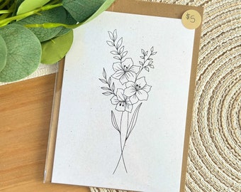 Puede incluir: Un dibujo lineal sencillo de un ramo de flores en una tarjeta blanca con borde marrón. La tarjeta tiene una etiqueta de precio que dice "5 €".