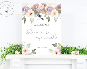 Op de afbeelding: Een welkomstbord met een aquarelbloemenrand in tinten paars, roze en groen. De tekst luidt "Welkom Olivia's Sprinkle April 22, 2023".