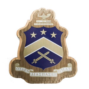 May include: A wooden crest with a blue and gold shield, three gold stars, crossed swords, and the text "OTANEN  DIASPAZSEI  HMAZ".