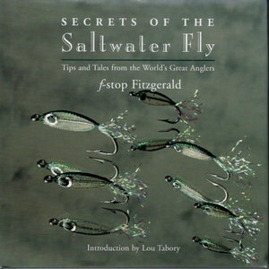 May include: A book cover titled "Secrets of the Saltwater Fly" with the author's name, f-stop Fitzgerald, and an introduction by Lou Tabory. The cover features illustrations of saltwater fishing flies in various sizes and orientations against a muted green background.