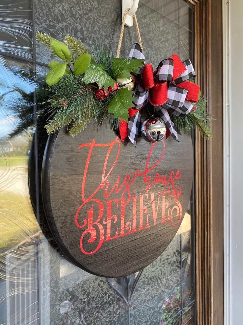 Christmas Door Hanger Christmas Wreath This House Believes Etsy
