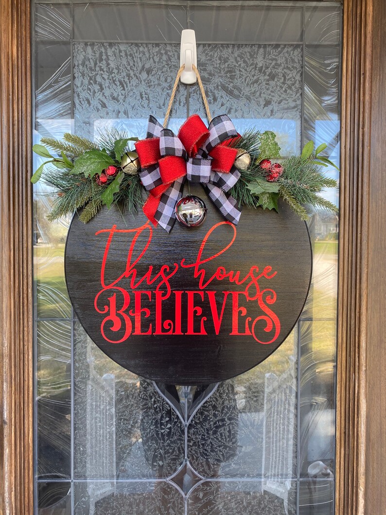 Christmas Door Hanger Christmas Wreath This House Believes Etsy