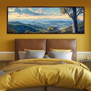 May include: A framed landscape painting depicts a mountain range under a cloudy sky. The artwork features shades of blue, green, and yellow, with a large tree on the right side. The painting is displayed above a bed with yellow bedding.