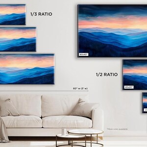 a living room with a couch and paintings on the wall