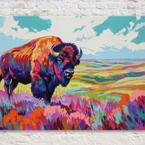 May include: A vibrant painting of a bison in a colorful landscape. The bison is depicted with a mix of red, orange, purple, and blue hues. The background features a field of colorful grasses and a blue sky with clouds. The artwork is displayed on a canvas.
