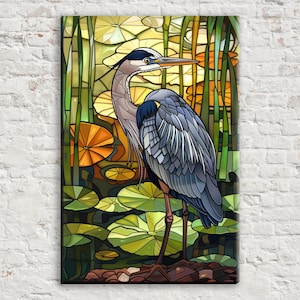May include: A stained glass-style artwork featuring a great blue heron standing in a pond. The heron has blue and gray feathers, a long beak, and is surrounded by lily pads and reeds. The background has yellow and orange tones.