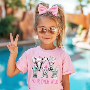 May include: A pink t-shirt with a graphic of five animals wearing party hats and glasses. The animals are an elephant, giraffe, zebra, lion, and tiger. The text "FOUR EVER WILD" is printed below the animals.