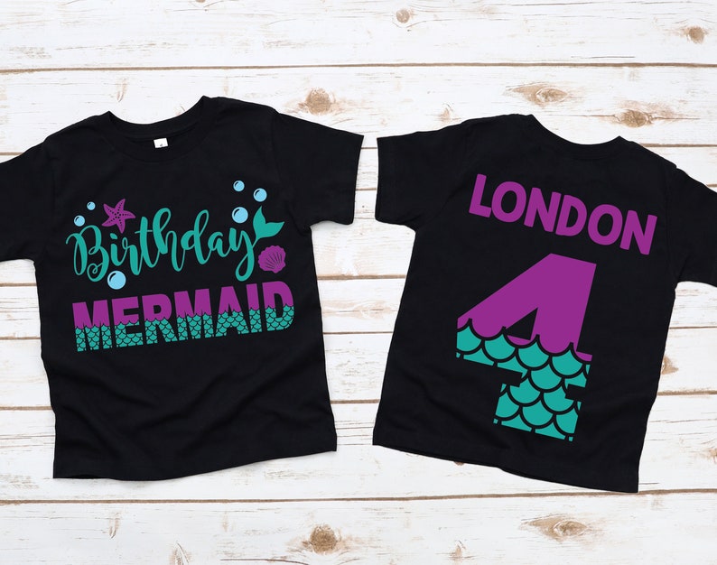 May include: Black t-shirt with a mermaid design and the text "Birthday Mermaid". The back of the shirt has a purple number 4 with a mermaid tail design and the name "LONDON" in purple text.