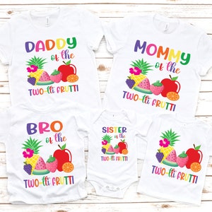 May include: A set of four white t-shirts with colorful fruit graphics and text that reads "Daddy of the Two-lit Frutti", "Mommy of the Two-lit Frutti", "Bro of the Two-lit Frutti", and "Sister of the Two-lit Frutti".