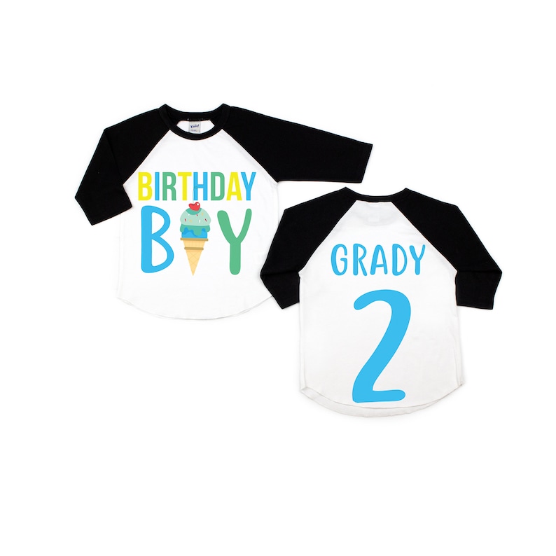 May include: Two white and black baseball shirts with a blue and green ice cream cone graphic. The front shirt says "Birthday Boy" and the back shirt says "Grady 2".