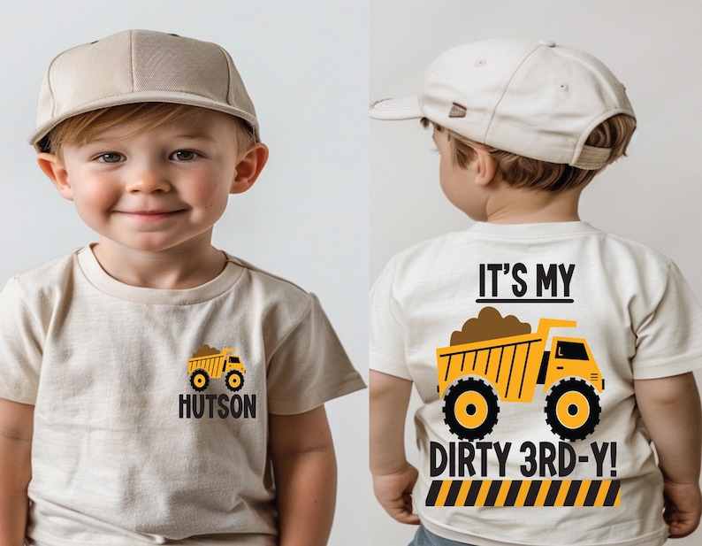 May include: A beige t-shirt featuring a small yellow dump truck graphic and the name Hutson on the front. The back displays a large yellow dump truck graphic with the text IT'S MY DIRTY 3RD-Y! above a black and yellow hazard stripe pattern.