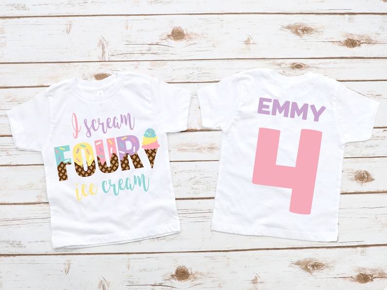 Puede incluir: Dos camisetas blancas con tem&aacute;tica de helado. La parte delantera de una camiseta dice "Yo grito cuatro helados" con un gr&aacute;fico de cono de helado colorido. La parte posterior de la otra camiseta dice "EMMY" en morado y tiene un gran n&uacute;mero rosa "4".