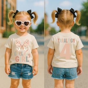 May include: A beige t-shirt featuring a butterfly design and the words "Birthday GIRL" in pastel shades. The back of the shirt displays the name "TARALEIGH" and the number "4". The child is wearing denim shorts and heart-shaped sunglasses.