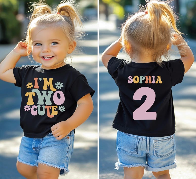 May include: A black t-shirt with the text "I'm Two Cute" in rainbow colors and a flower design. The back of the shirt has the name "Sophia" and the number "2" in rainbow colors.