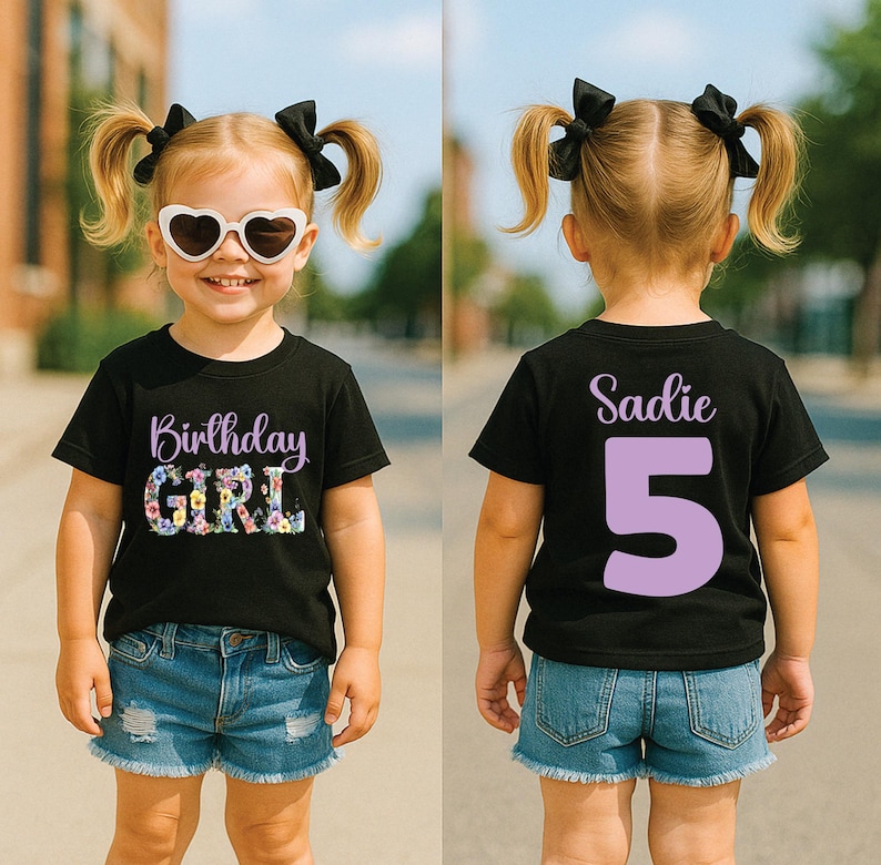 May include: A black short-sleeve t-shirt featuring the text Birthday Girl with floral lettering on the front and the name Sadie with the number 5 in large light purple font on the back, paired with blue denim shorts and heart-shaped sunglasses.