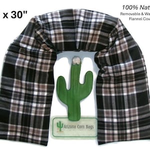 May include: A black, white, and brown plaid flannel cover, 5" x 30", surrounds a green cactus-shaped object. The text "100% Natural Removable & Washable Flannel Cover" is visible. The product is labeled "Arizona Corn Bags".