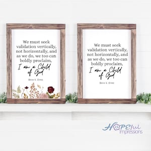 May include: Two framed prints with a white background and a wooden frame. Each print features the text "We must seek validation vertically... I am a Child of God." Floral accents in burgundy, pink, and brown are at the bottom.
