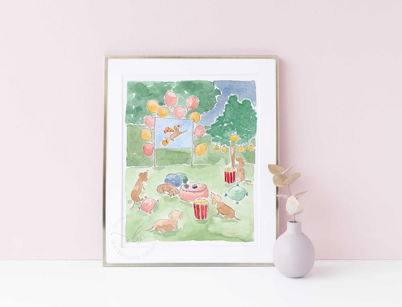 May include: Watercolour print depicting a dog party. The illustration shows dachshunds at a picnic with popcorn, balloons, and a movie screen. The colour scheme includes greens, pinks, yellows, and blues, creating a joyful scene.