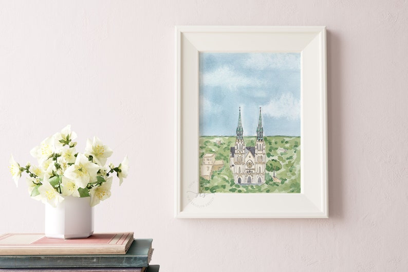 May include: Watercolor painting of a church with two tall spires, surrounded by green trees and a blue sky with white clouds.