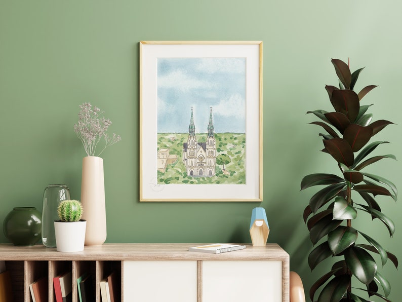 May include: A watercolor painting of a church with two tall spires, surrounded by green trees and a blue sky with white clouds.