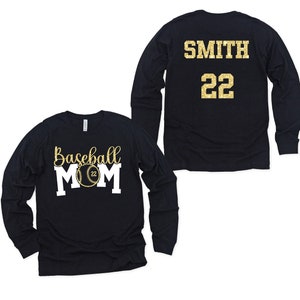 May include: Two long-sleeved shirts, one black with the text "Baseball Mom" and a baseball graphic, the other black with the text "SMITH 22" in gold glitter.