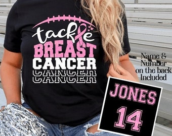 May include: Black t-shirt with a pink ribbon and the text "tackle breast cancer" in white and pink. A black and pink sign with the text "JONES 14" is in the lower right corner. The text "Name & Number on the back Included" is in the upper right corner.