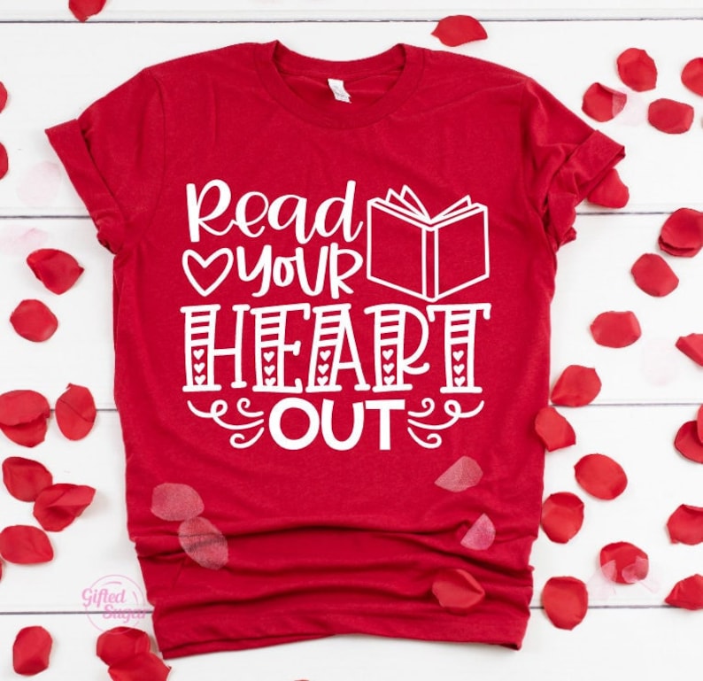 May include: Red t-shirt with white text that reads "Read your heart out" with a book and heart graphic.