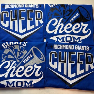 May include: Four royal blue t-shirts with white and black glitter text that reads "Richmond Giants Cheer" and "Cheer Mom". The shirts feature a white and black glitter cheerleading pom-pom and megaphone graphic. The megaphones have the names "Moore", "Arianne", and "Mom" written on them.