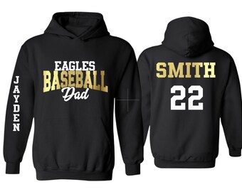 May include: Two black hooded sweatshirts. One has the text "EAGLES BASEBALL Dad" in gold lettering on the front and "JAYDEN" in white lettering on the sleeve. The other has the text "SMITH 22" in white and gold lettering on the back.