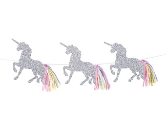 May include: A silver glitter unicorn banner with three unicorns and rainbow yarn tails.