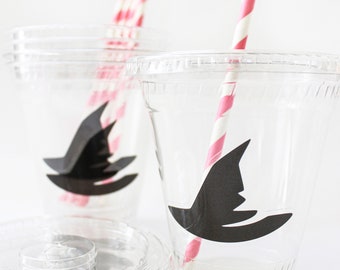 May include: Two clear plastic cups with black witch hat stickers and pink and white striped straws.