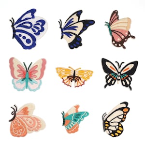 May include: Nine embroidered iron-on patches featuring colorful butterfly designs. The butterflies are in various colors, including blue, pink, yellow, green, and black.