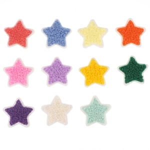 May include: Twelve colorful star-shaped patches with fuzzy texture. The stars are in various colors including pink, purple, blue, green, orange, yellow, and white.