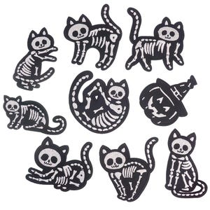 May include: Set of ten iron-on patches featuring black and white skeleton cats in various poses. The patches are perfect for adding a spooky touch to clothing, bags, or other accessories.