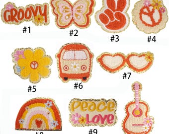 May include: Ten colorful iron-on patches with a groovy theme. The patches feature a peace sign, a butterfly, a rainbow, a groovy text, a flower, a van, a heart-shaped sunglasses, a guitar, and a peace and love text.